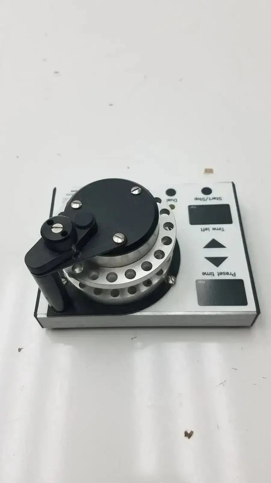 Black and silver cma microfraction collector model 142 miniature turntable with circular platter control knobs and digital display panels