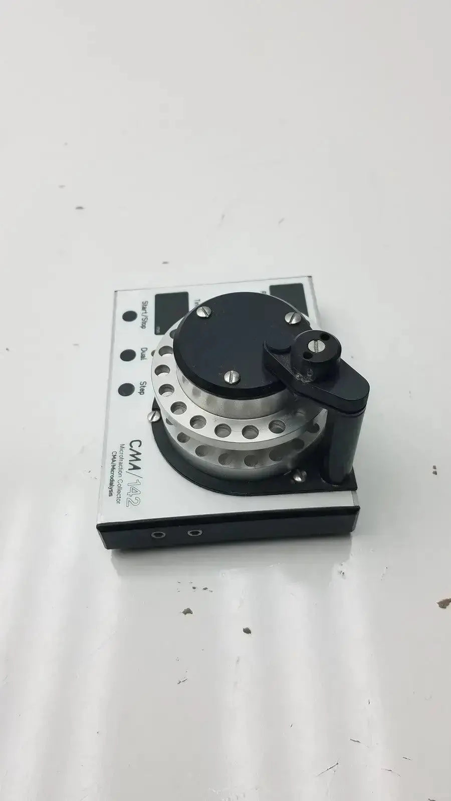Black and silver cma microfraction collector model 142 audio interface with circular dial and multiple input output ports