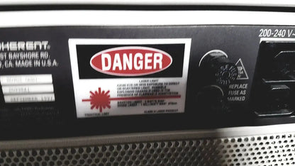 Black back panel of coherent novus omni opthalmic photocoagulation laser system with red danger label and 220 volt input