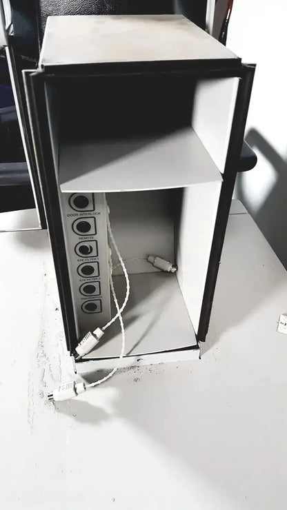Black and white mini-fridge with multiple audio input ports on side of coherent novus omni opthalmic photocoagulation laser system back