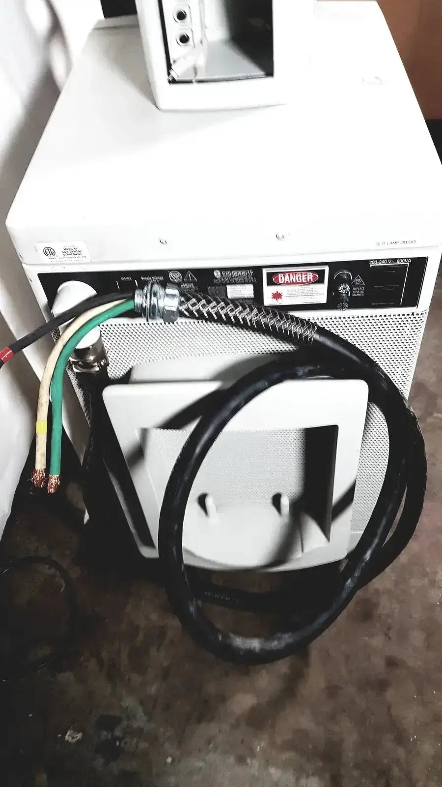 Rear panel of coherent novus omni white ophthalmic photocoagulation laser system with coiled hose and colored wiring