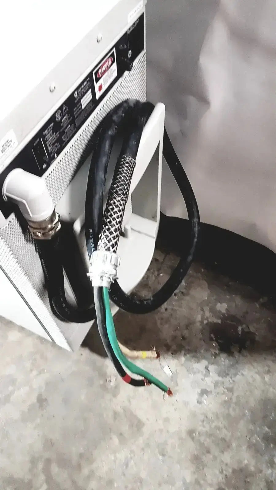 Black industrial hose with mesh protective sleeve and multicolored wiring on back side of coherent novus omni opthalmic laser system