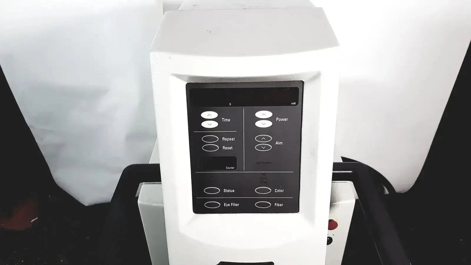 White medical grade laser device with black control panel and labeled buttons for power aim and color coherent novus omni