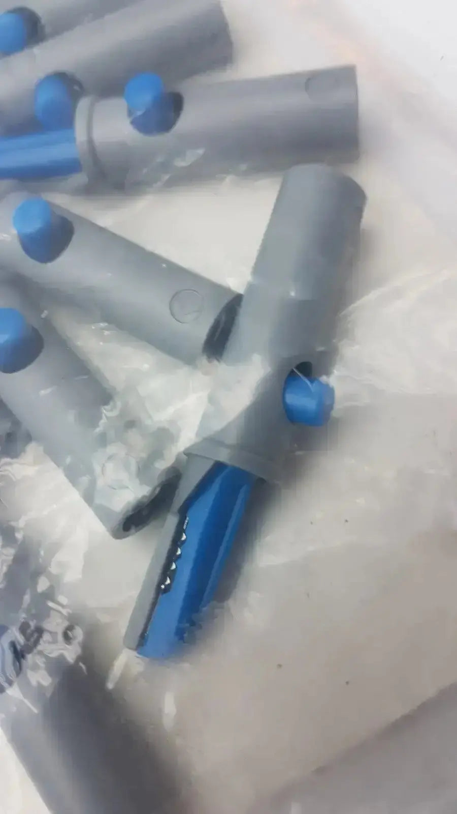 Gray and blue plastic conmed banana adapter with cylindrical body and open end showing metallic contacts 10/pk