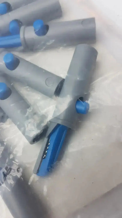 Gray and blue plastic conmed banana adapter with cylindrical body and open end showing metallic contacts 10/pk
