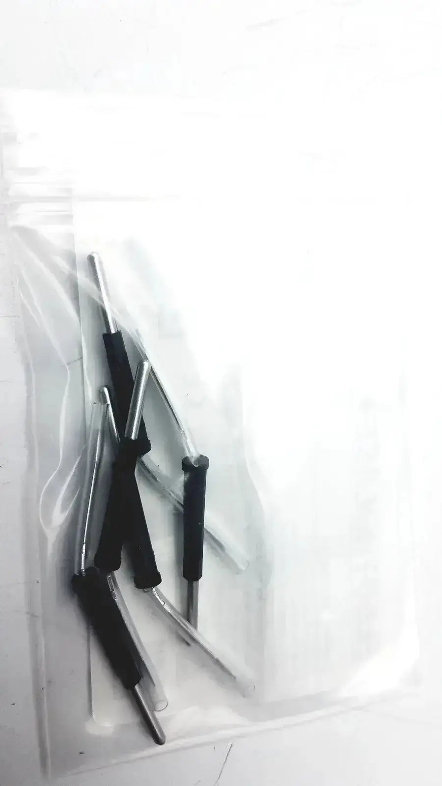 Black-handled precision screwdrivers with metallic shafts in a clear bag for conmed hyfrecator used medical equipment sale