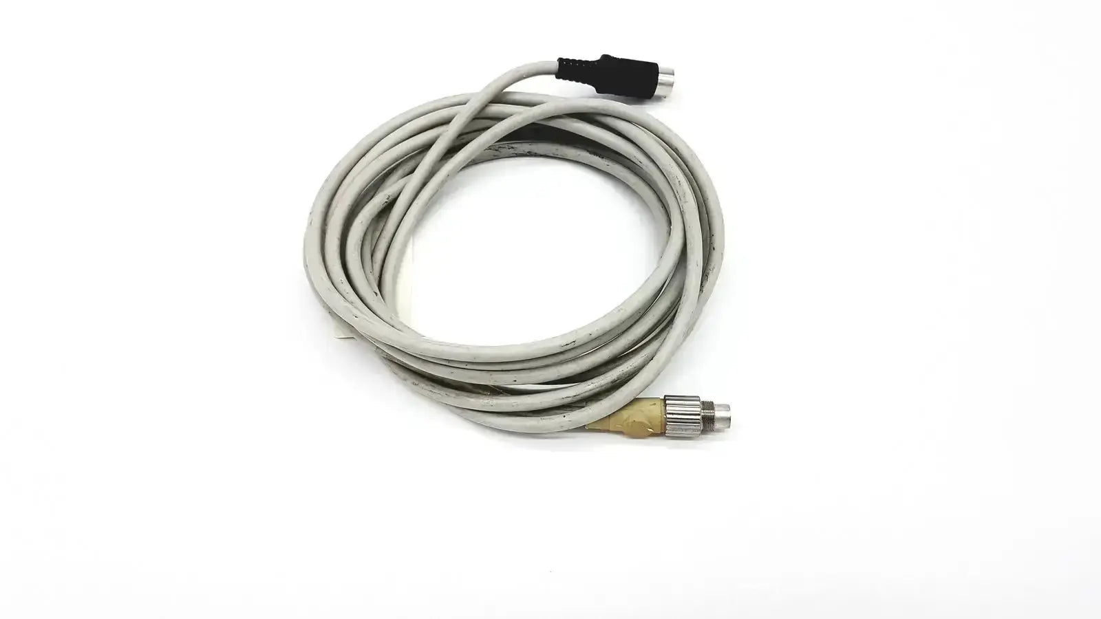 Gray coiled control techniques connecting cable with black and metallic connectors for industrial use
