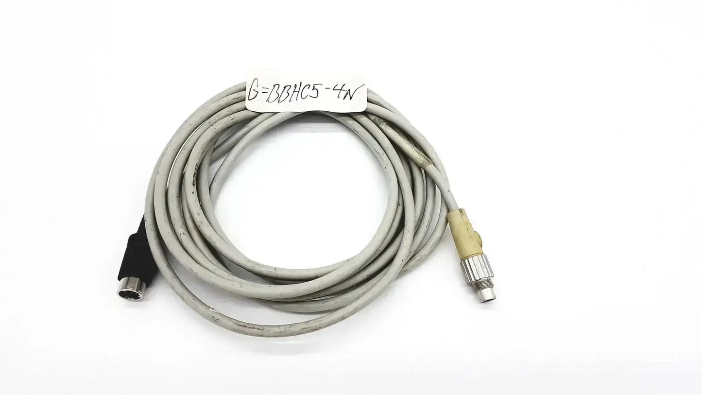 Gray coiled control techniques connecting cable with black and beige connectors for industrial equipment connection