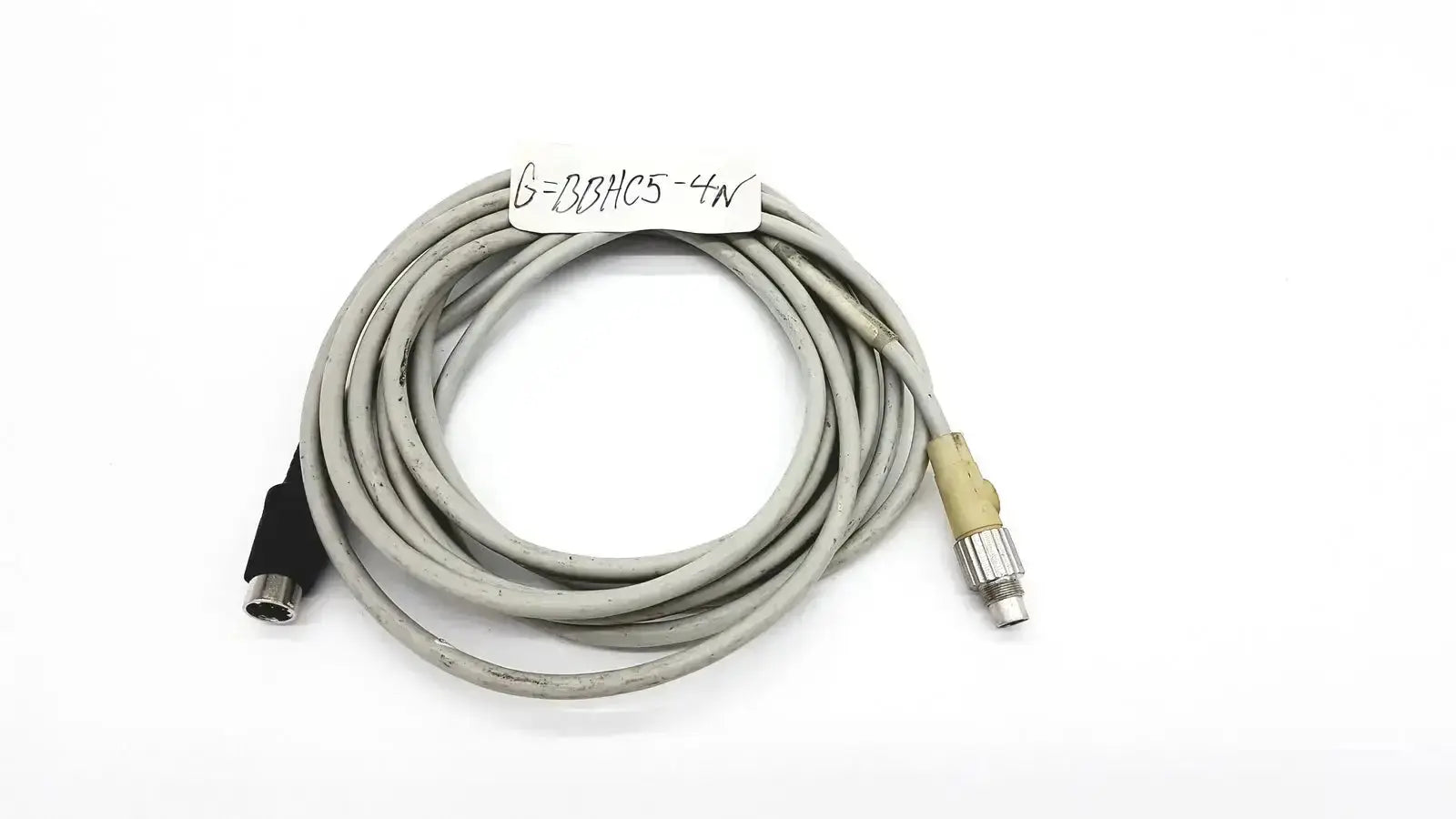 Gray coiled control techniques connecting cable with black and beige connectors for industrial equipment connection