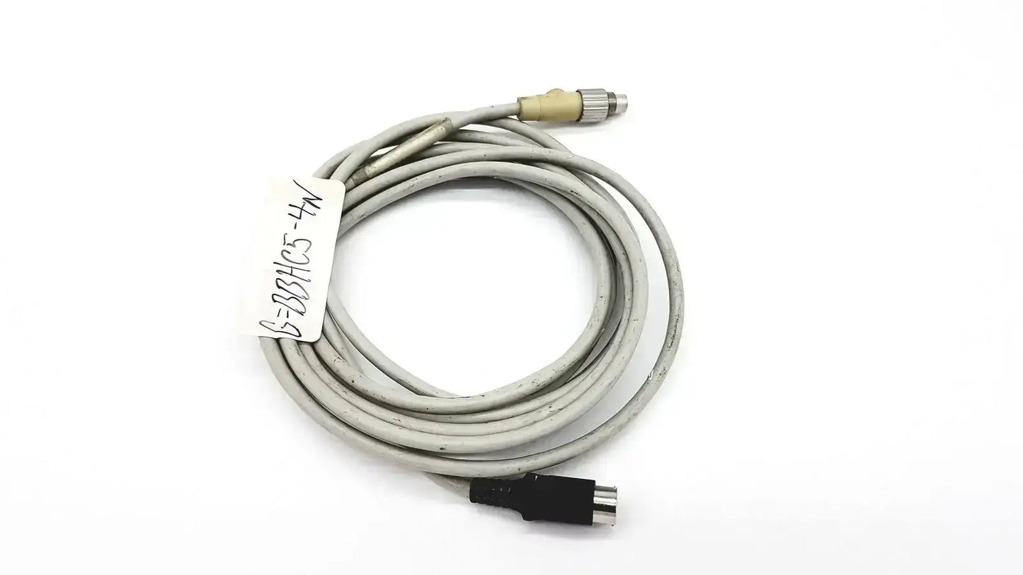 Gray coiled control techniques connecting cable with beige metallic and black plastic connectors for industrial use