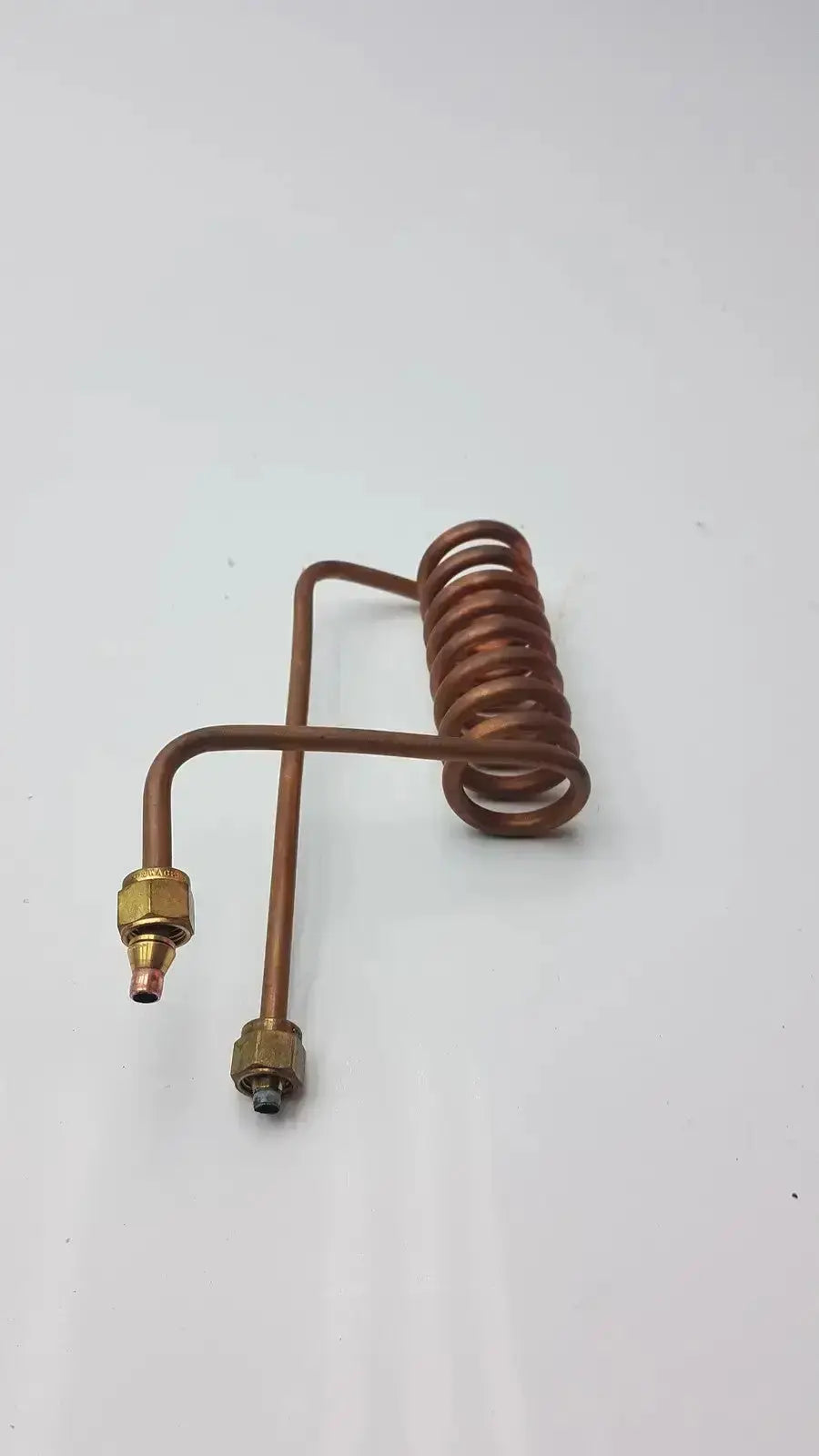 Copper-colored coiled fin tube coil heat exchanger with brass fittings made of copper nickel fin material