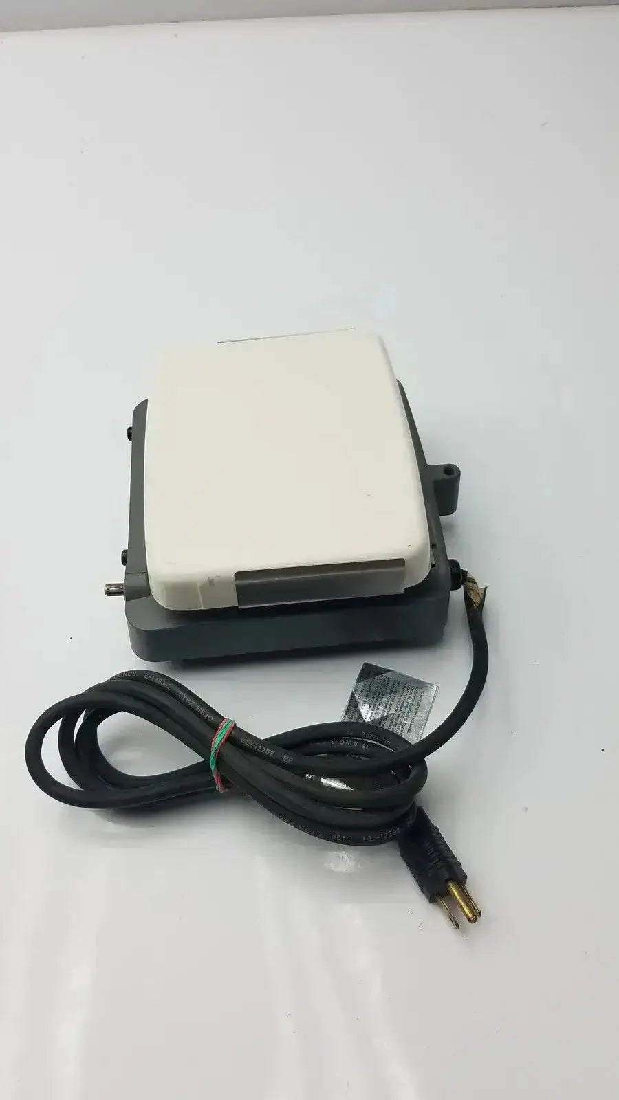 Black and white electric foot pedal with coiled power cord for corning laboratory stirrer model RC-310 use