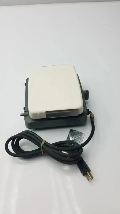 Black and white electric foot pedal with coiled power cord for corning laboratory stirrer model RC-310 use