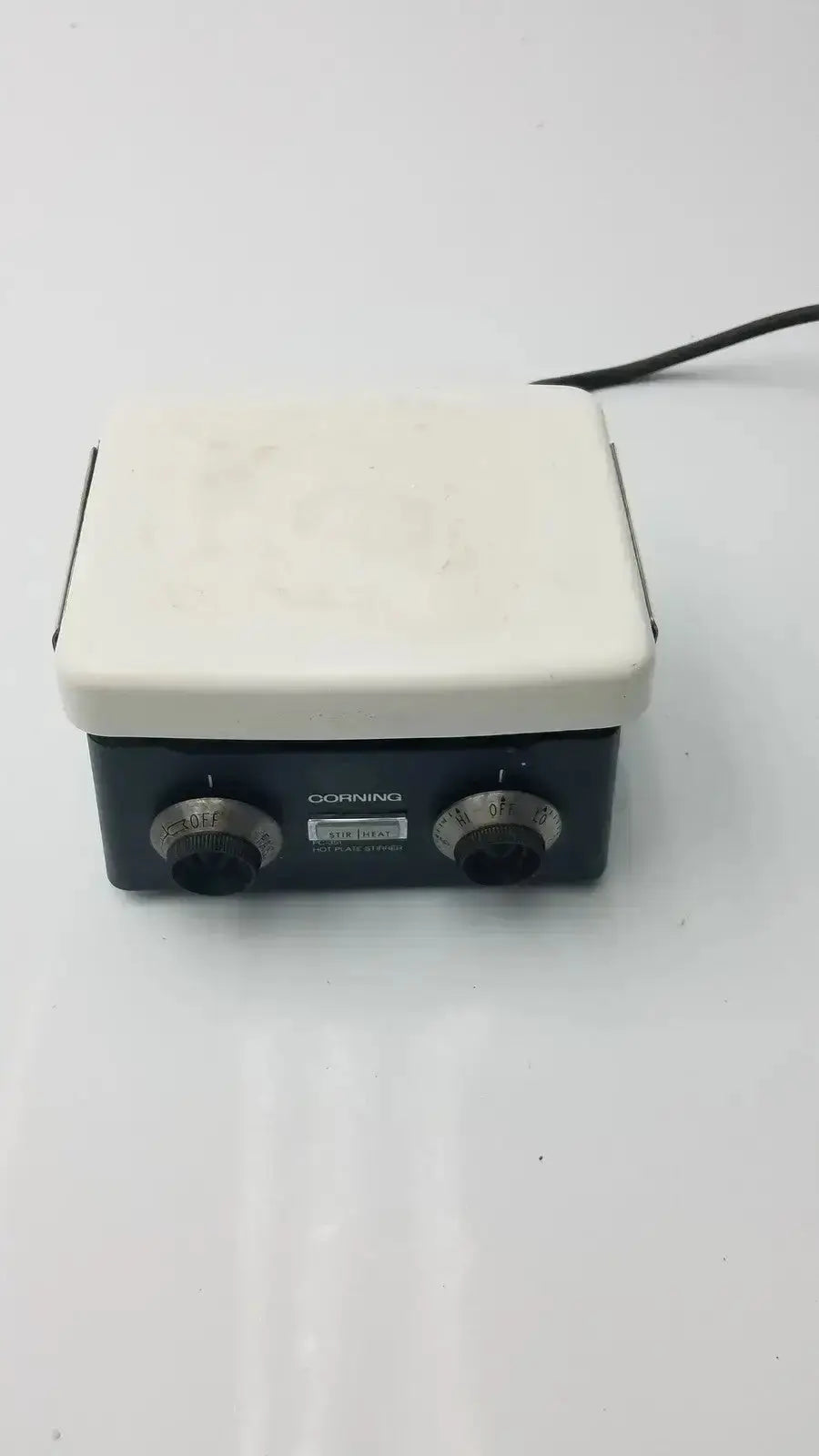Black and white corning pc-351 hot plate stirrer with two rotary knobs for precise temperature control