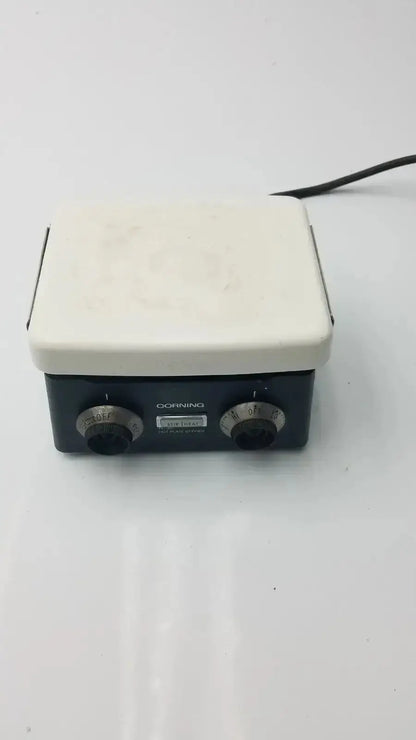 Black and white corning pc-351 hot plate stirrer with two rotary knobs for precise temperature control