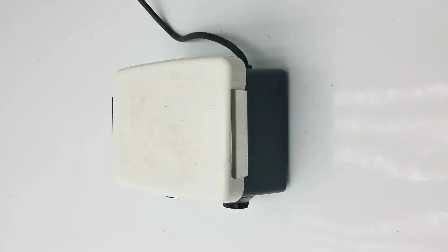 White and black plastic aquarium air pump with coiled power cord shown alongside corning pc-351 hot plate stirrer mixer hotplate magnetic