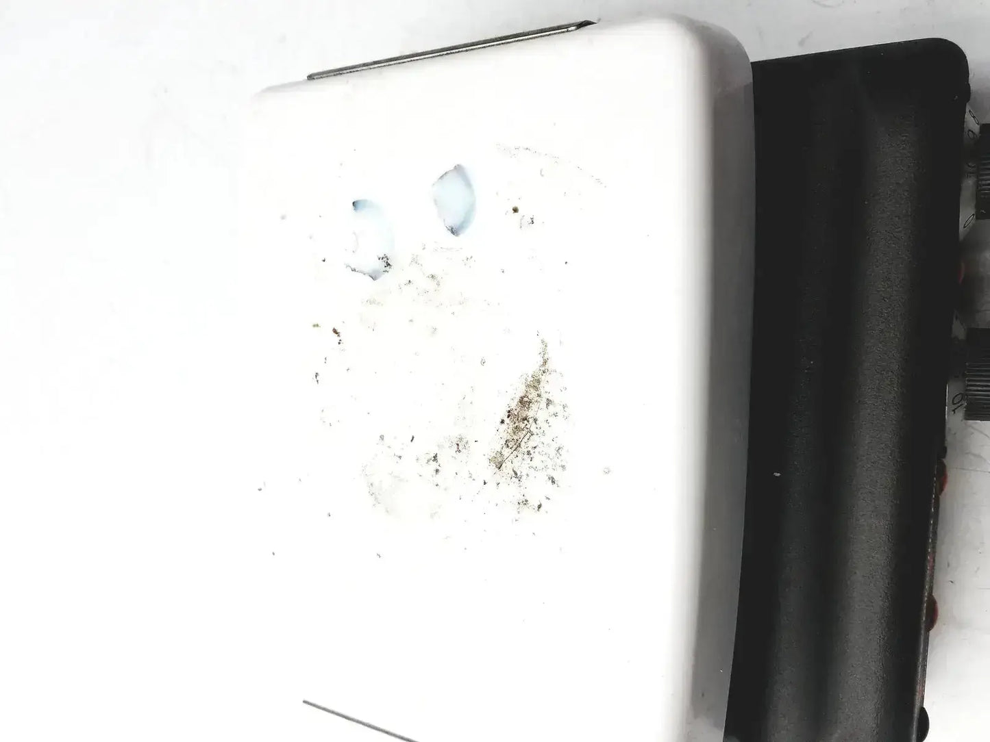 White plastic wall-mounted soap dispenser with residue buildup shown alongside corning pc420 magnetic hot plate stirrer