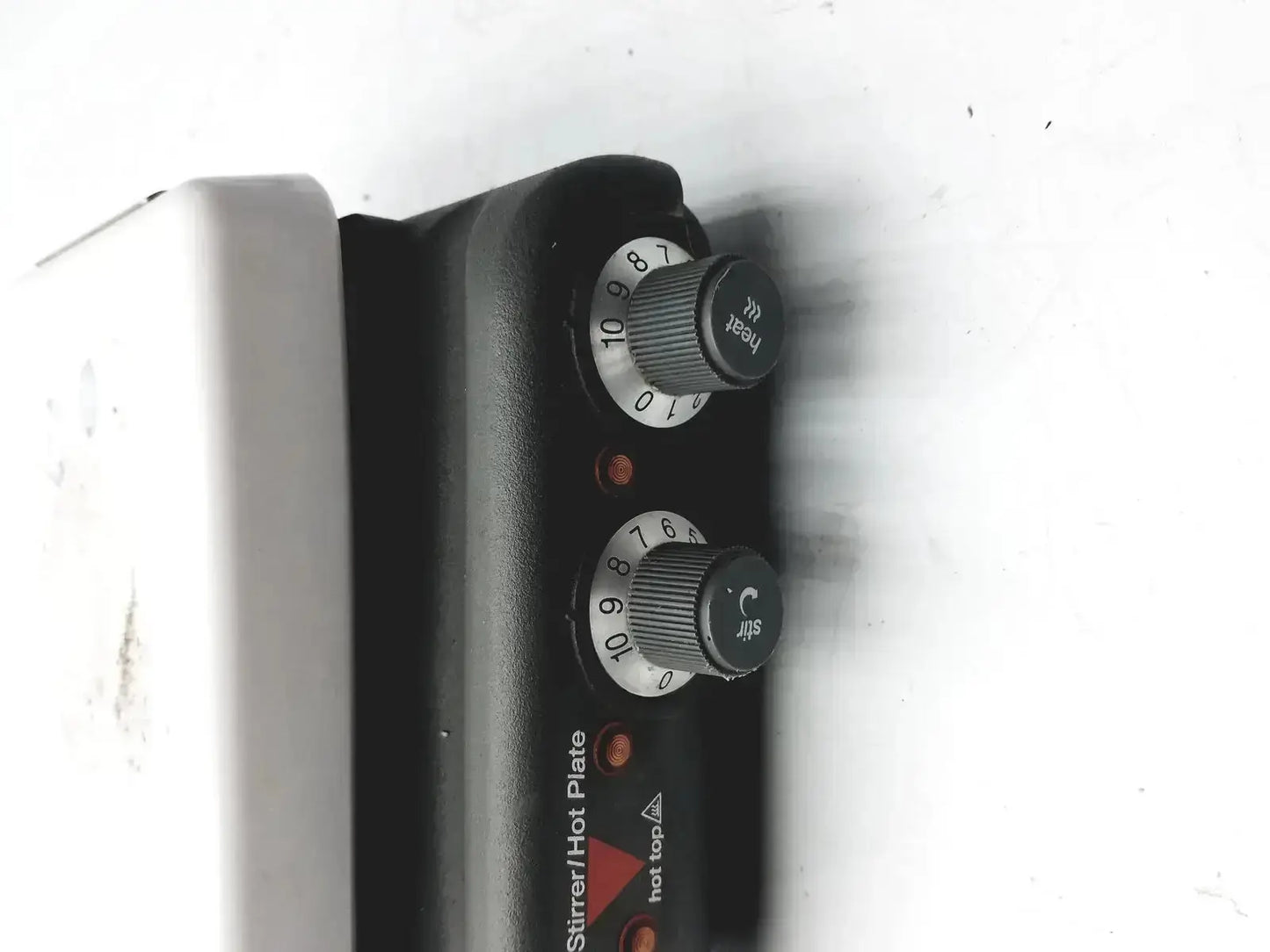 Black plastic control panel with rotary dials labeled heat and stir on silver corning pc420 magnetic hot plate stirrer