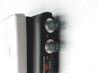 Black plastic control panel with rotary dials labeled heat and stir on silver corning pc420 magnetic hot plate stirrer