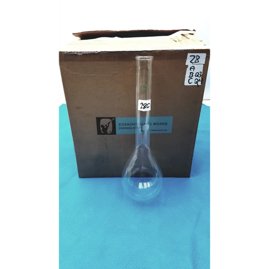 Clear glass volumetric flask with a long neck and bulbous base, labeled ’28c’ on its side.