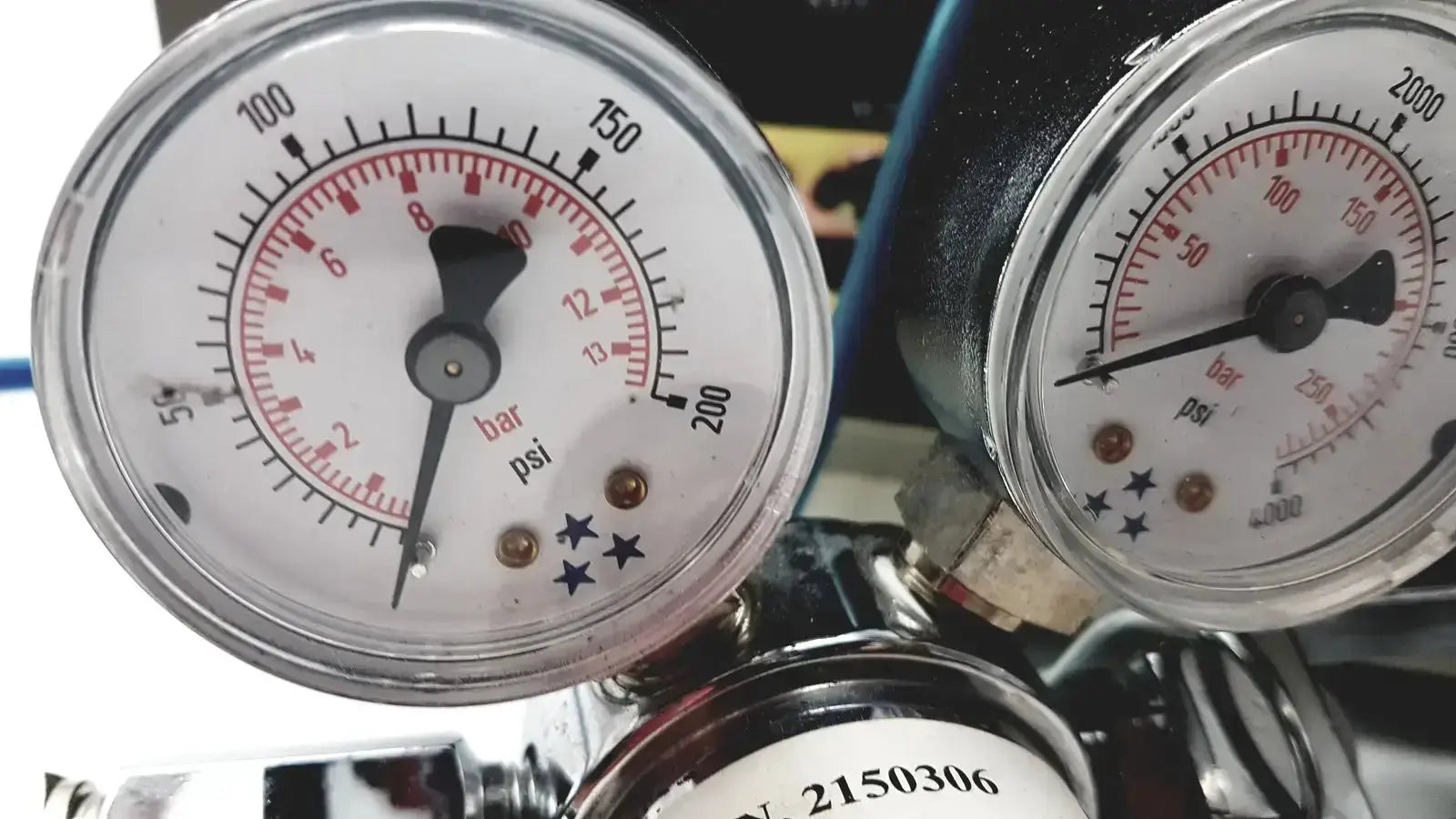 Two circular pressure gauges with white faces red markings and black needles on cosmed quark b2 pulmonary gas exchange device
