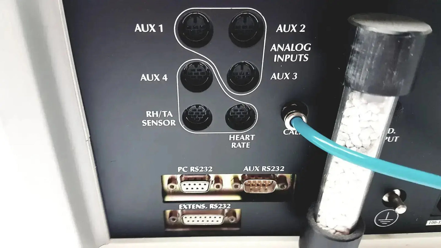 Black panel with labeled auxiliary inputs and rs232 ports on the back side of cosmed quark b2 pulmonary gas exchange unit