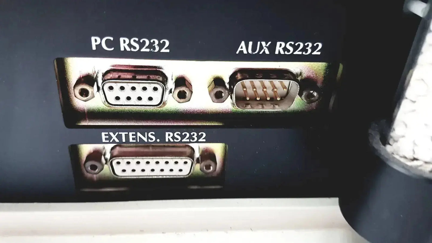 Back side of cosmed quark b2 pulmonary gas exchange device showing three metallic rs232 serial ports labeled pc aux extens