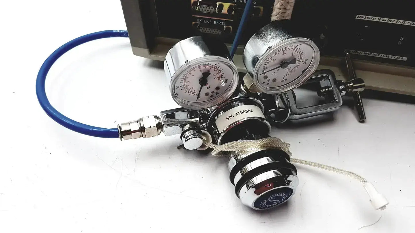 Silver dual-gauge gas regulator with black and chrome accents connected to a blue hose for cosmed quark b2 pulmonary gas exchange