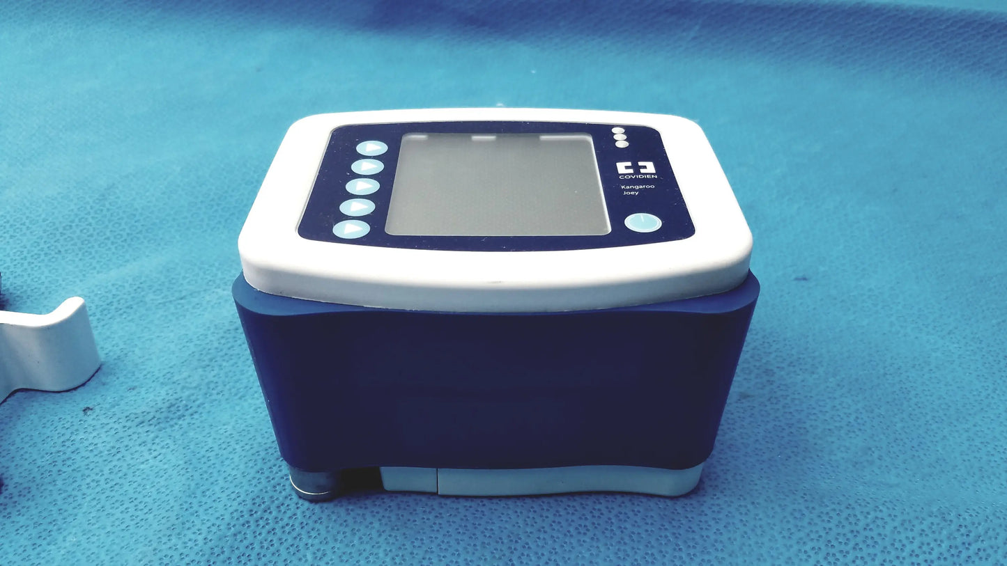 White and navy blue digital blood pressure monitor with rectangular screen and circular buttons on left side for kangaroo joey pole clamp flush pump