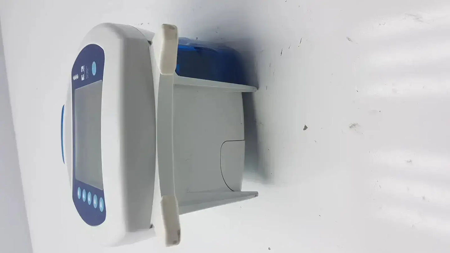 White and blue Covidien Kangaroo Pump enteral feeding pump device with digital screen buttons and open compartment housing blue component