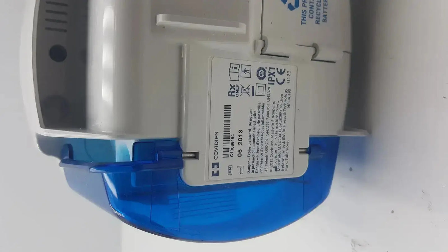 Blue and gray covidien kangaroo pump enteral feeding pump device with white label showing regulatory markings and barcode