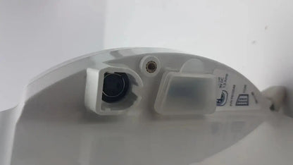 White plastic toilet lid with black flush button and translucent cover on covidien kangaroo enteral feeding pump device