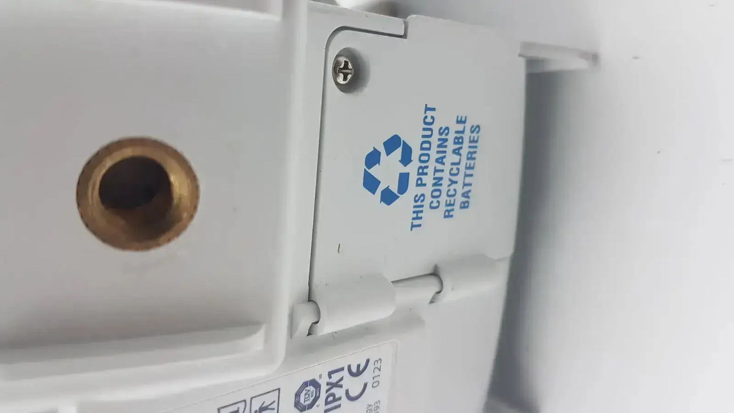 White plastic Covidien kangaroo pump enteral feeding pump device with brass port and blue recycling symbol for batteries