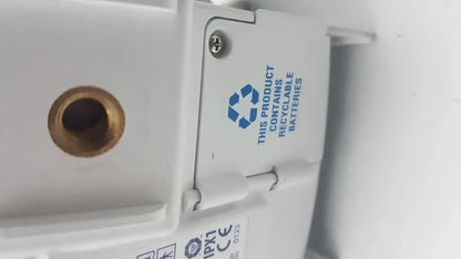 White plastic Covidien kangaroo pump enteral feeding pump device with brass port and blue recycling symbol for batteries