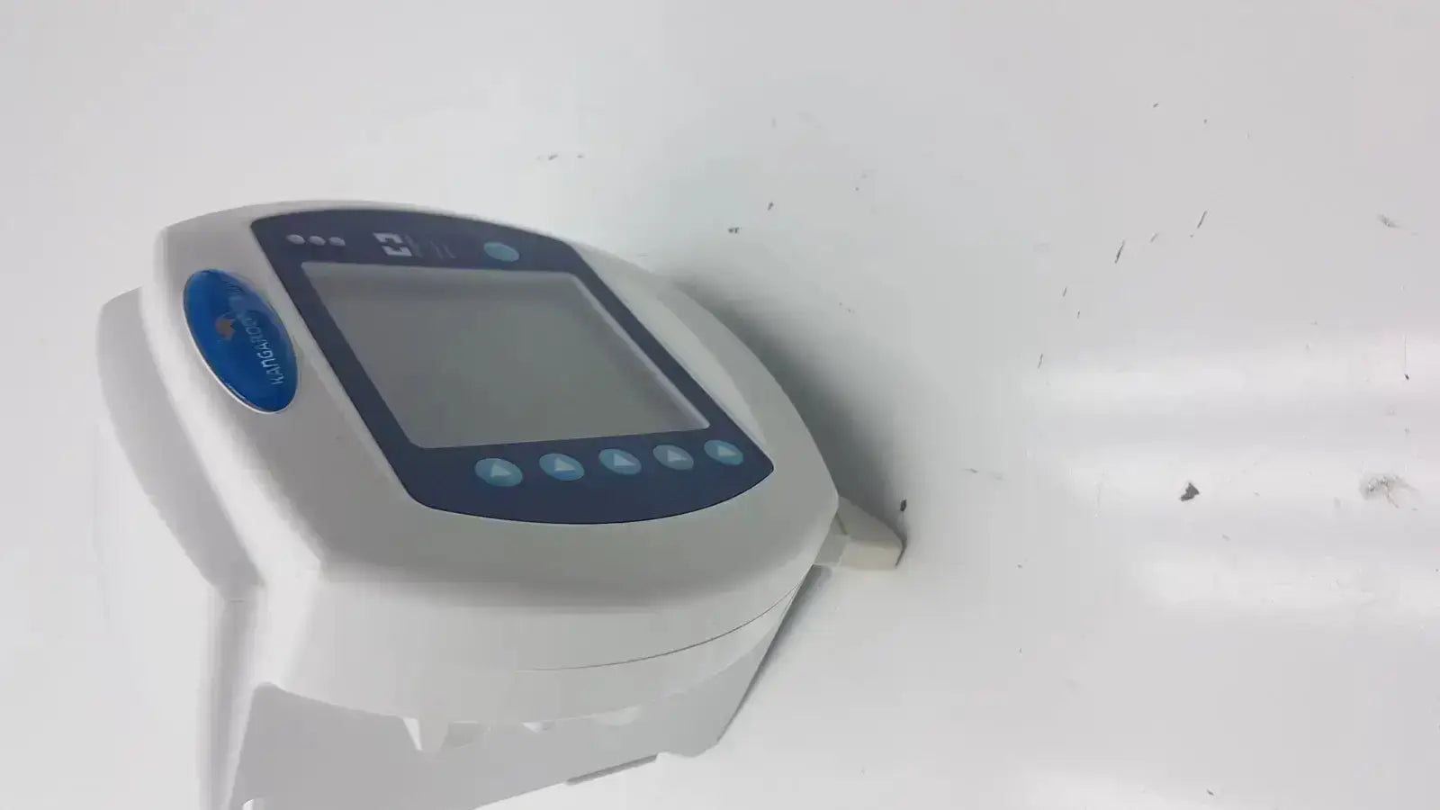 White plastic covidien kangaroo enteral feeding pump device with blue button and lcd screen control panel
