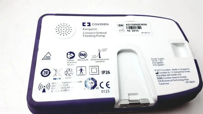 Purple and white covidien kangroo feeding pump with connect pole clamp and extras for enteral feeding use