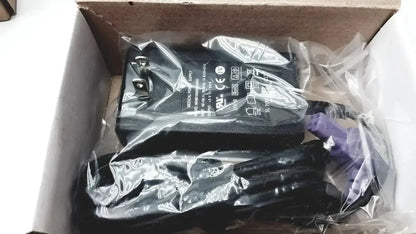 Black plastic power adapter with coiled cable in clear packaging for covidien kangroo feeding pump pole clamp extras
