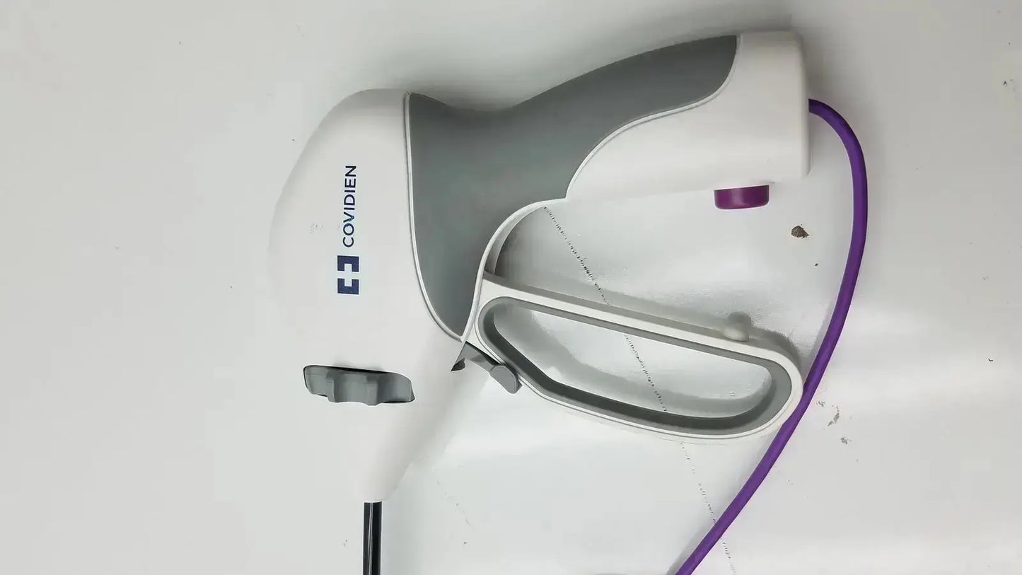 White and gray handheld covidien ligasure maryland jaw sealer divider with purple cord branded covidien on side