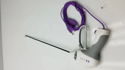 White and gray handheld covidien ligasure maryland jaw sealer divider with long black shaft and purple power cord