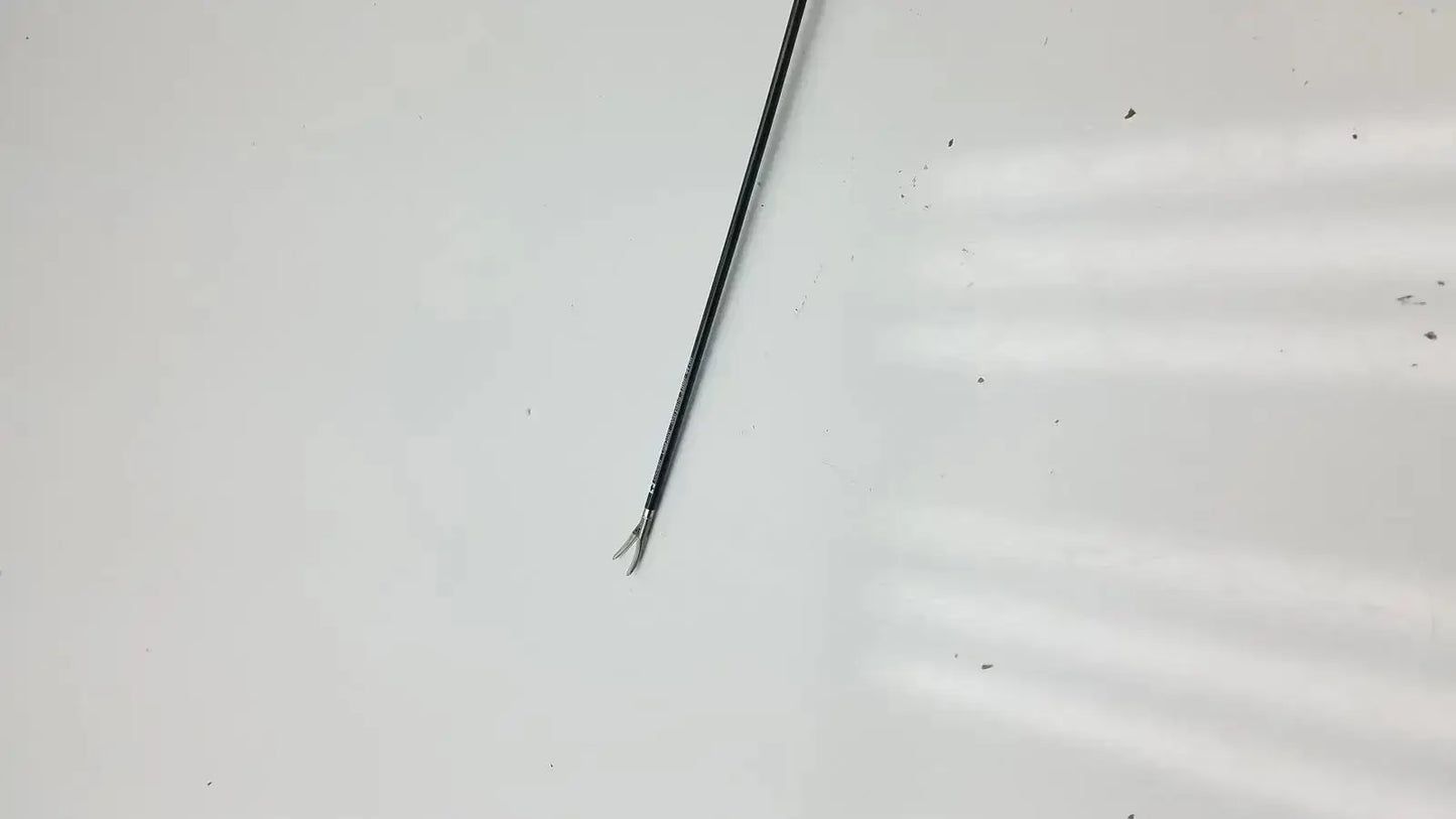 Black metal covidien ligasure maryland jaw sealer divider with slender curved tip and fine serrations along shaft