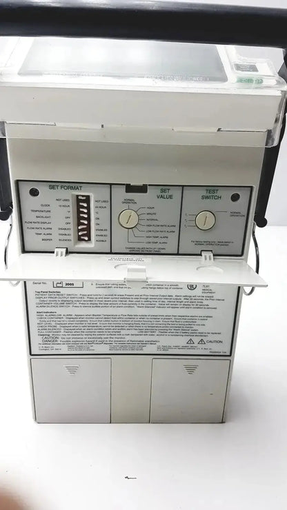 White industrial control panel with black labels and two rotary dials for criticore fluid output and temperature monitor model 000002n