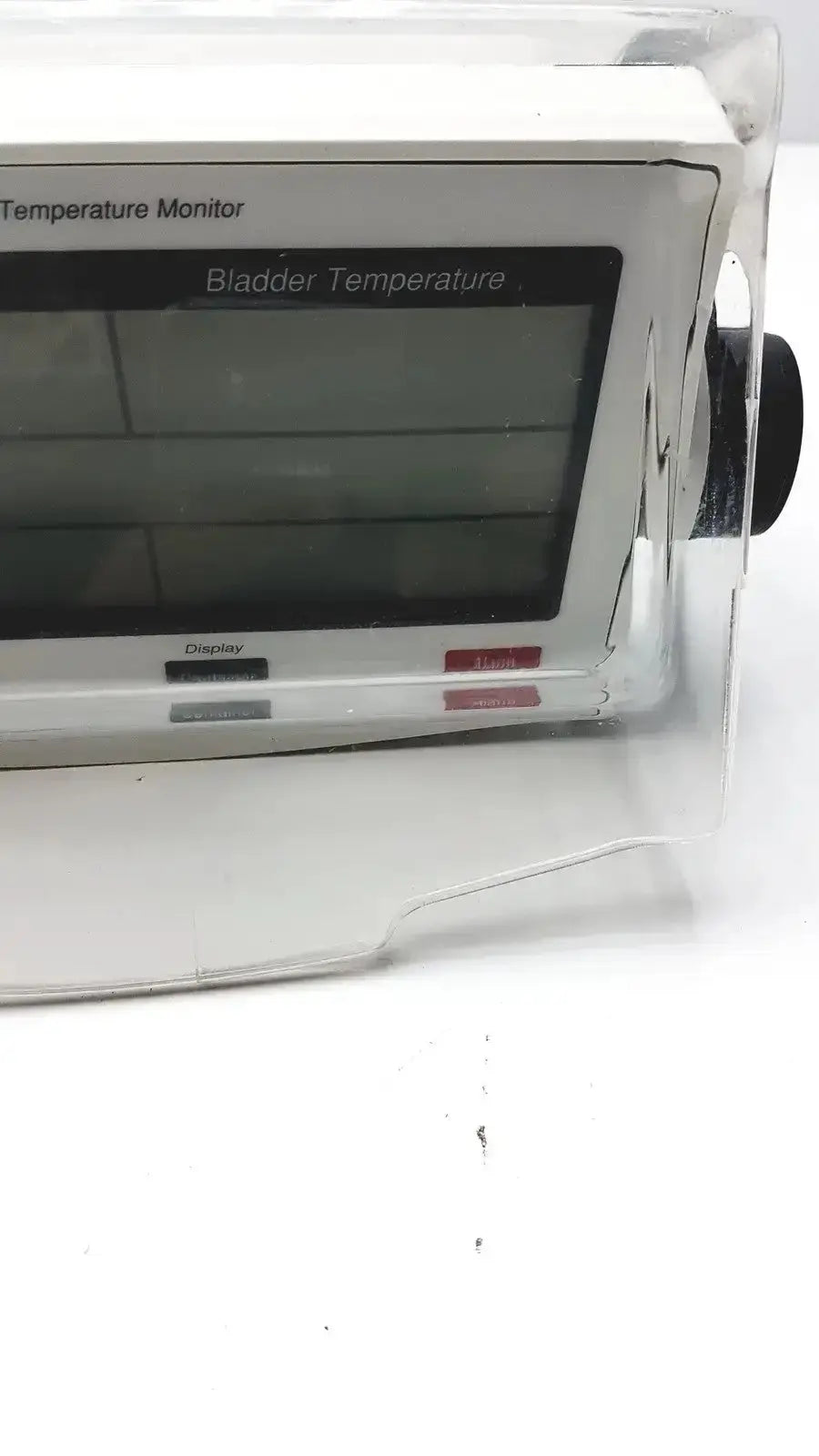 White plastic criticore fluid output temperature monitor model 000002n with digital screen displaying bladder temperature