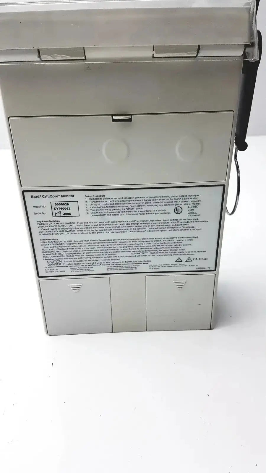 White rectangular panel with printed text showing specifications for criticore fluid output temperature monitor model 000002n