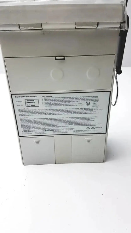 White rectangular panel with printed text showing specifications for criticore fluid output temperature monitor model 000002n