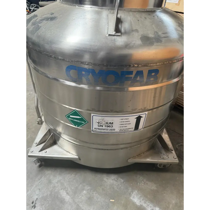 Stainless steel cryofab vacuum tank with blue lettering and safety labels.