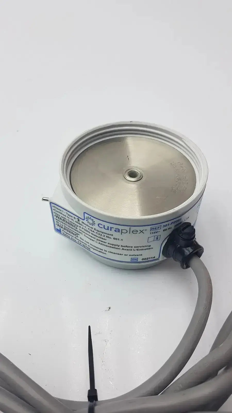 Silver cylindrical humidifier heater p2001c with metallic top and black connector labeled curaplex 301-p2001