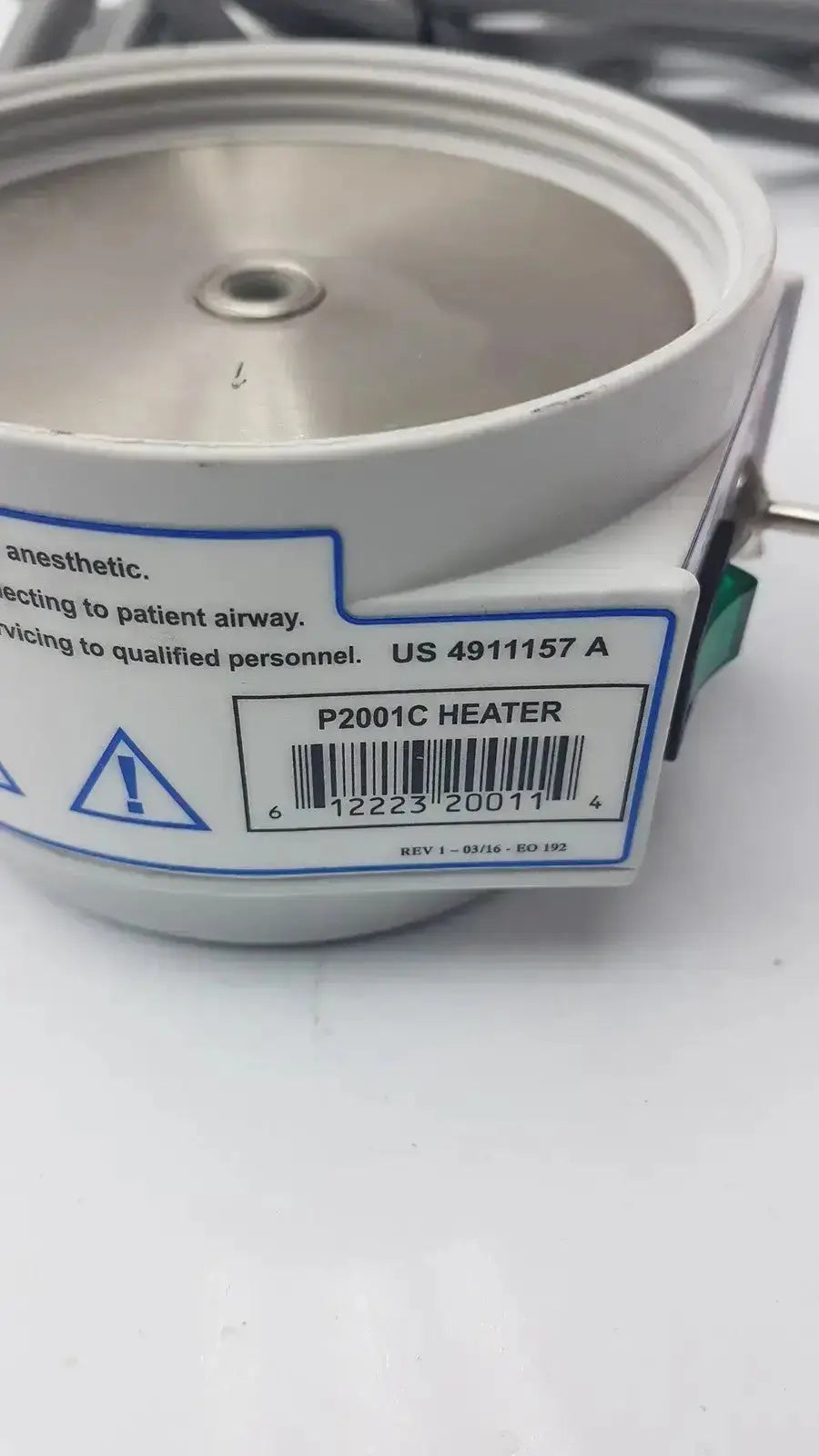 White cylindrical medical humidifier heater p2001c with metallic top and model label curaplex 301-p2001