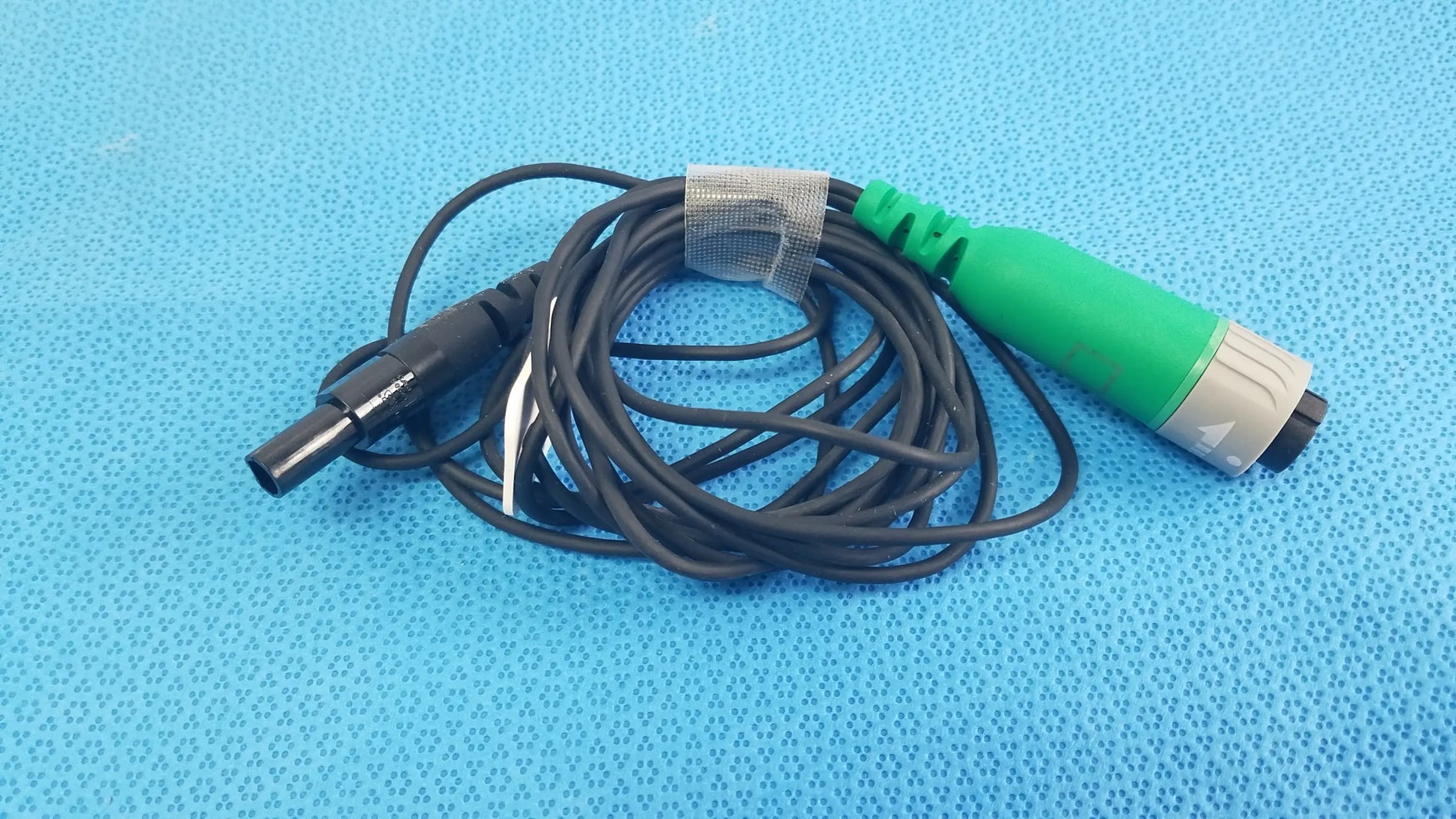 Black coiled catheter connector cable with green gray connector and black plug for reuse medical equipment in EnSite X EP system