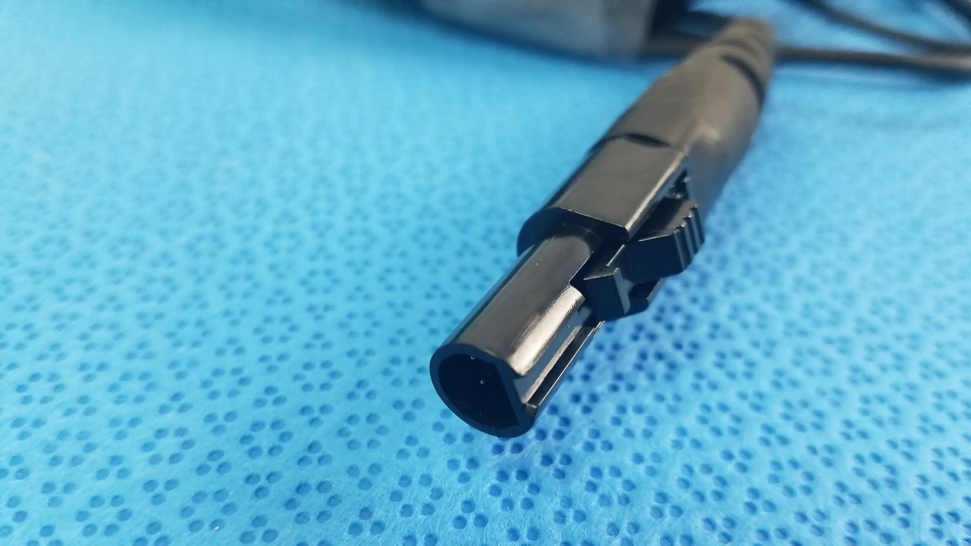 Black plastic cylindrical catheter connector cable with ridged locking mechanism for reuse medical equipment, EnSite X EP system