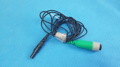 Green and gray medical catheter connector cable with black coiled wire for reuse medical equipment in EnSite X system